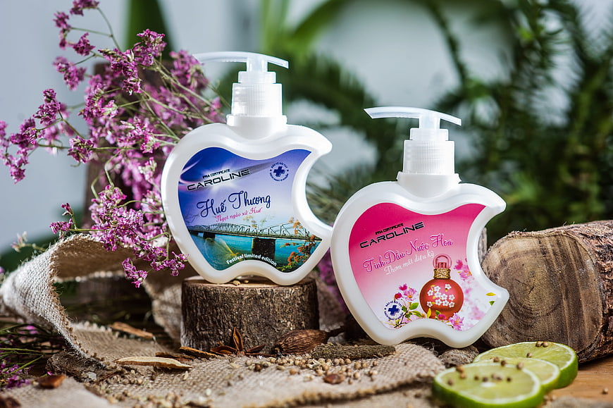 Apple-shaped perfume bottles with flowers and lime slices