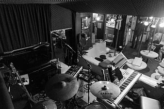 Black and white photo of empty music stage with instruments