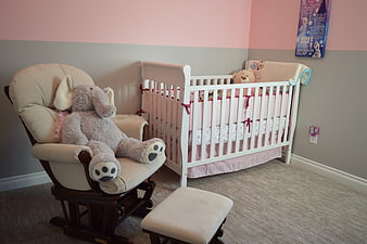 Cozy baby nursery with white crib and rocking chair