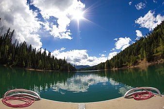 Fisheye View from Boat on Turquoise Lake with Pine Forest