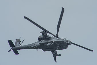 Military Attack Helicopter Flying Against Overcast Sky