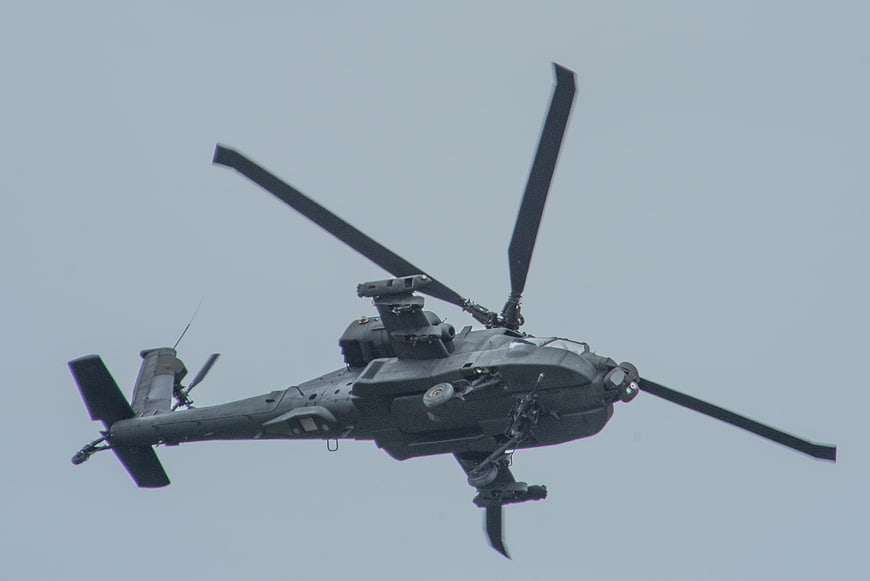 Military Attack Helicopter Flying Against Overcast Sky