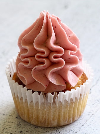 Pink Frosted Cupcake In White Paper Liner On Marble Surface