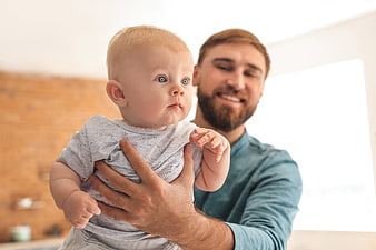 Father Holding Baby Boy at Home