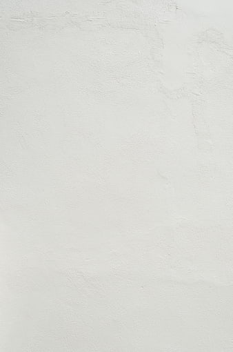 White textured wall background with subtle surface details