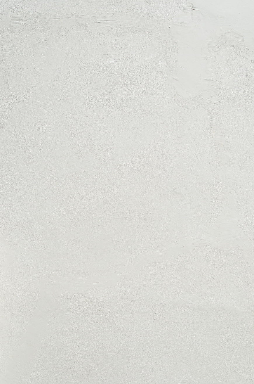 White textured wall background with subtle surface details