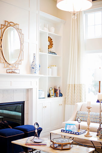 Bright Elegant Living Room With White Built-Ins And Gold Accents