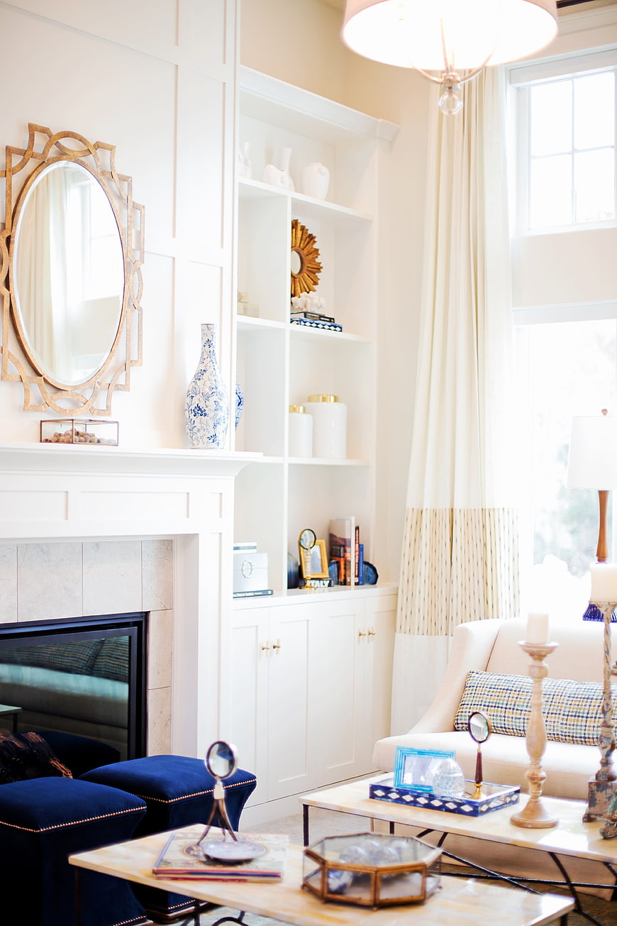 Bright Elegant Living Room With White Built-Ins And Gold Accents