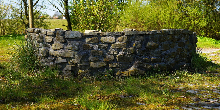 Old Stone Well Structure In Green Garden Landscape
