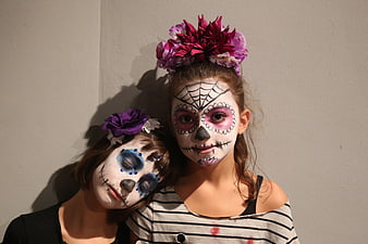 Two Young Women Wearing Day of the Dead Catrina Face Paint