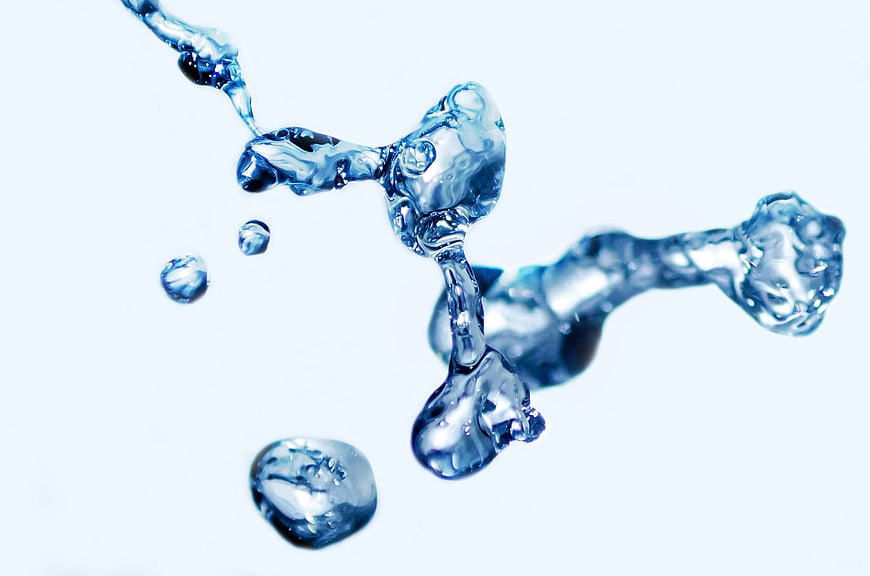 Dynamic blue water splash frozen in mid-air against white background