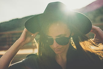Woman in Hat and Sunglasses with Sun Flare