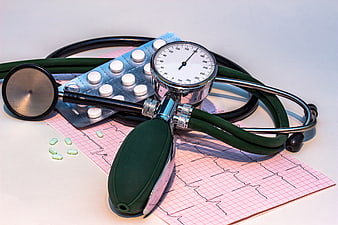 Medical equipment with stethoscope, pills, and ECG print