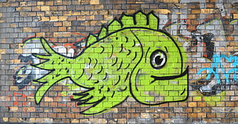 Green Graffiti Fish Mural on Brick Wall