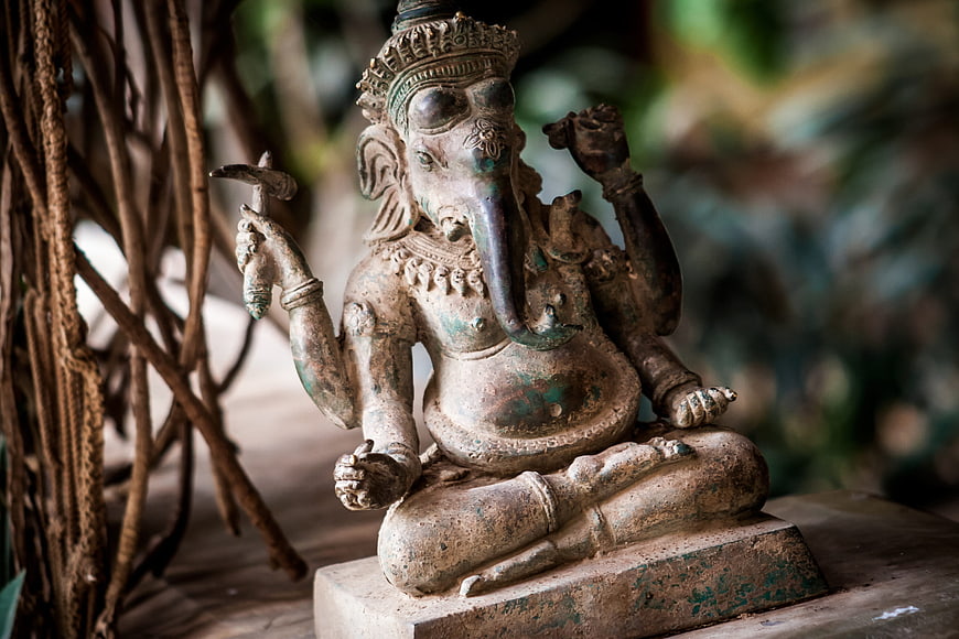 Weathered Stone Ganesha Statue in Serene Temple Setting