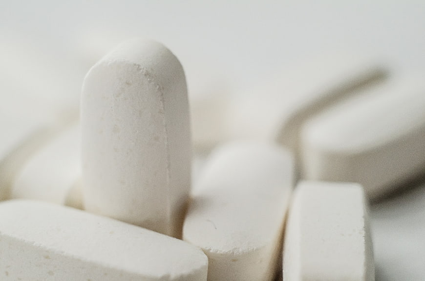 Close-up of white pharmaceutical pills on a clean background