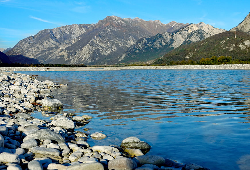 Scenic river landscape with rocky shore and mountains
