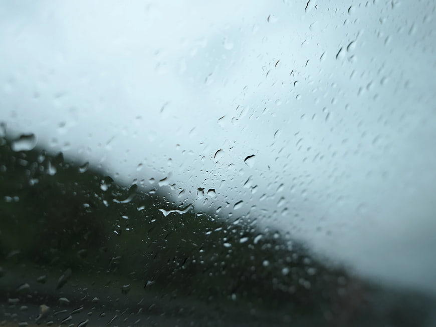 Raindrops on Window Glass with Blurred Background