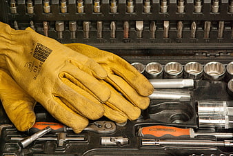 Yellow leather work gloves on mechanic tool set