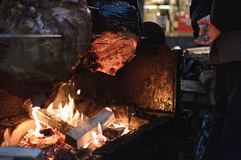 Roasting Pork Leg on Open Fire in Winter