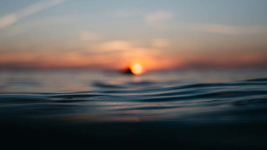 Blurred Sunset Over Ocean Waves with Soft Focus