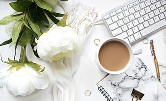 White peonies, coffee, and workspace flat lay on marble