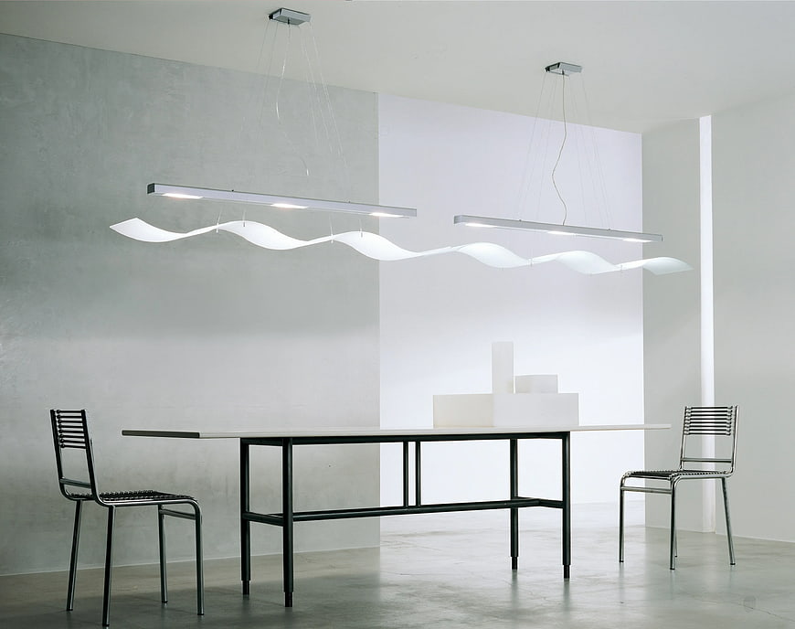 Modern minimalist dining room with wavy pendant lights