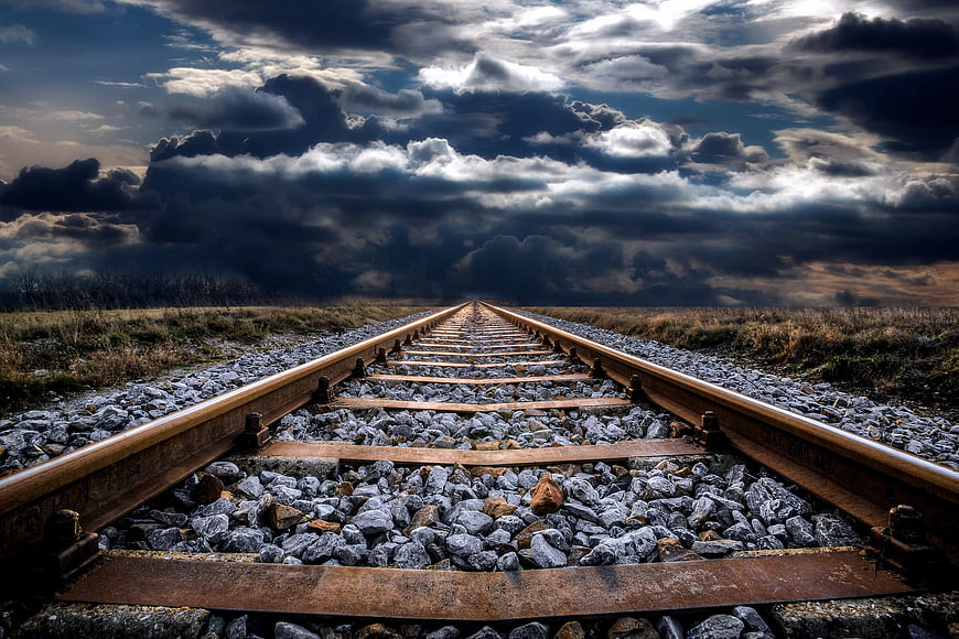 Dramatic Railway Tracks Leading Into Stormy Clouds