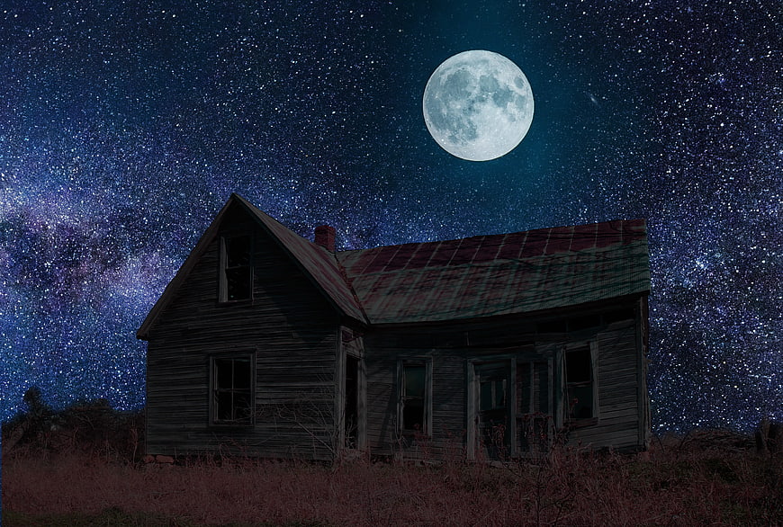 Abandoned Haunted House Under Starry Night Sky with Full Moon