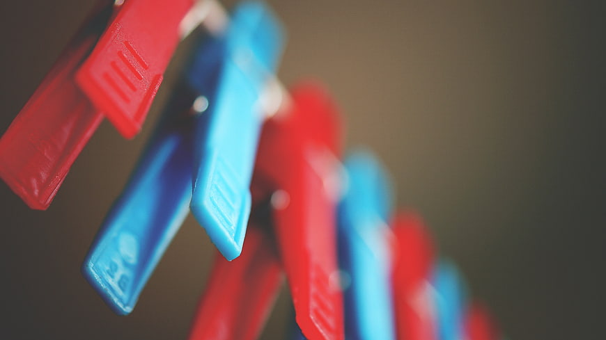 Close-up of red and blue clothespins on a line