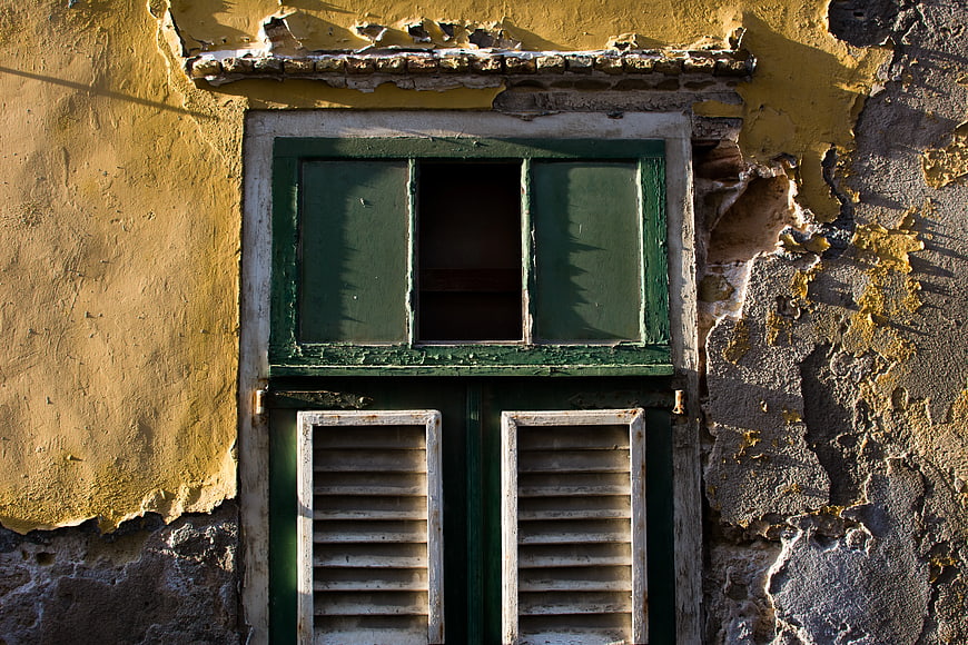 Weathered Green Window on Peeling Yellow Wall