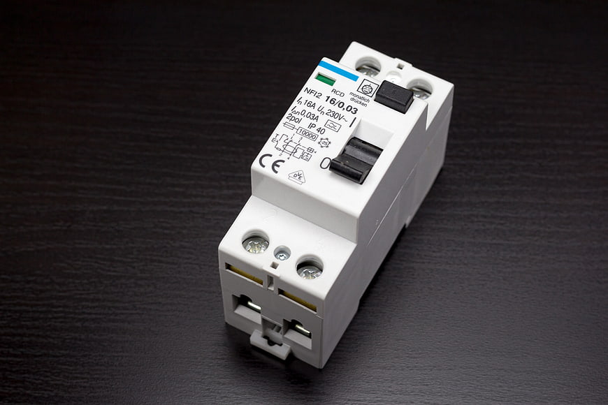 White DIN Rail RCD Circuit Breaker on Dark Surface