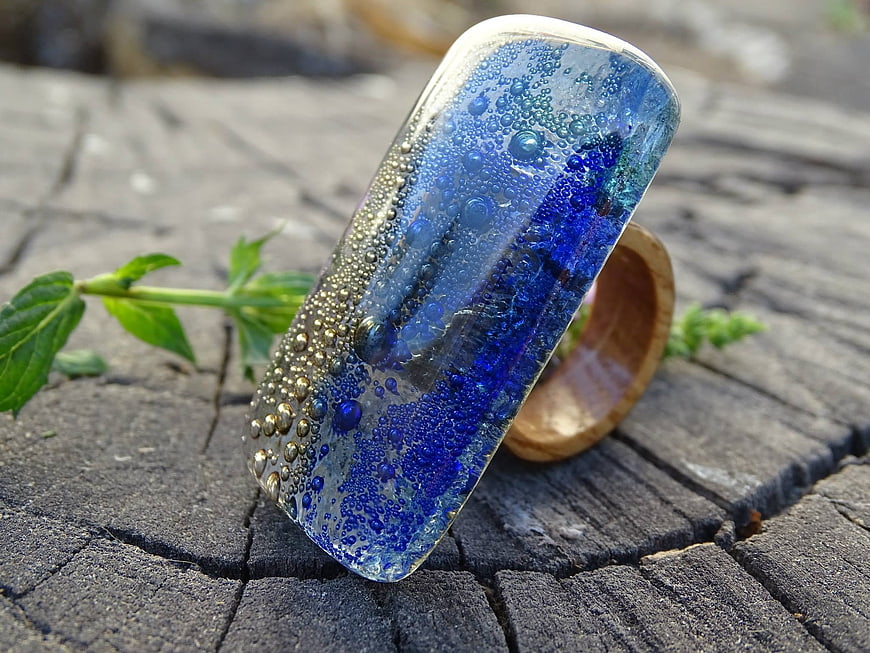 Handcrafted Blue Glass and Wood Ring on Weathered Wood