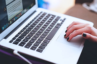 Woman's Hand Using Laptop Trackpad