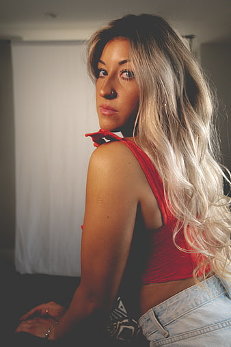 Blonde Woman in Red Top Looking Back Over Shoulder
