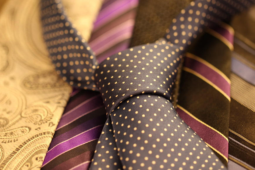Close-up of patterned business neckties and cravats in a pile