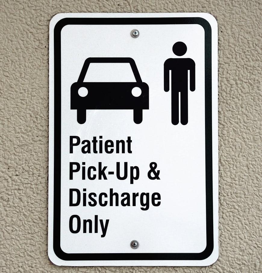 Patient Pick-Up and Discharge Only Sign on Wall