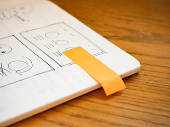 Wireframe Sketches on Notebook with Sticky Note