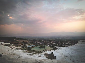 Pamukkale Travertine Terraces at Sunset with Distant Town