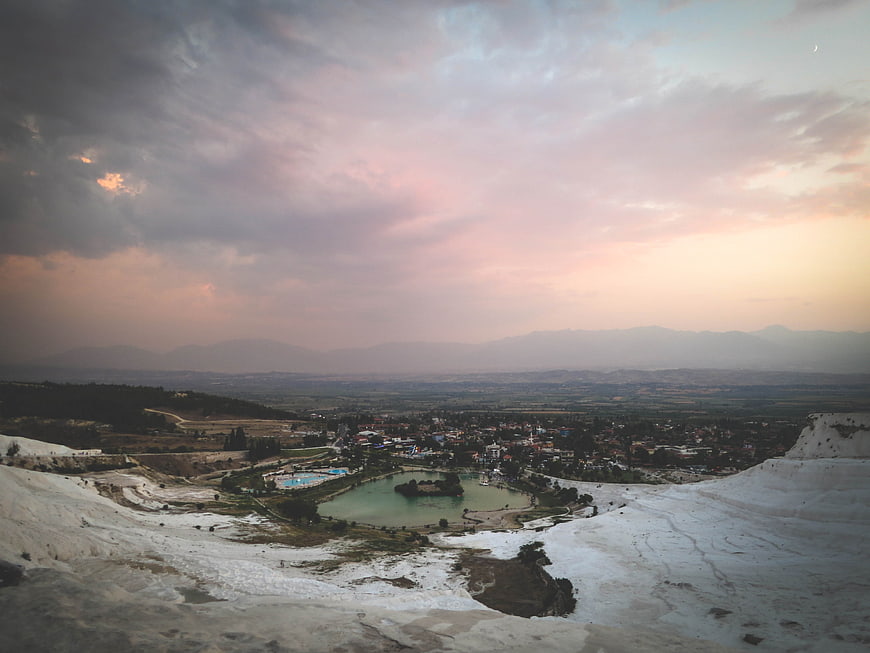 Pamukkale Travertine Terraces at Sunset with Distant Town