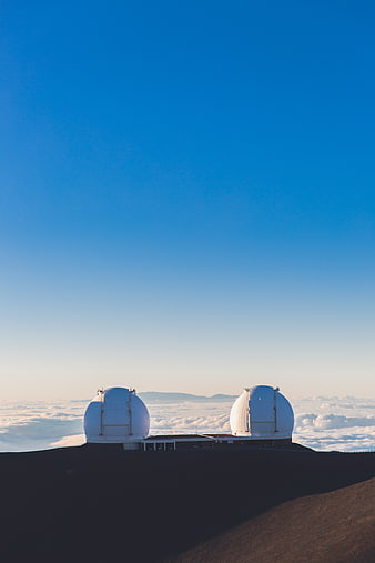 Observatory Domes Above Clouds on Mountain Peak