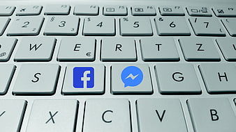 Facebook and Messenger Icons on White Computer Keyboard Keys
