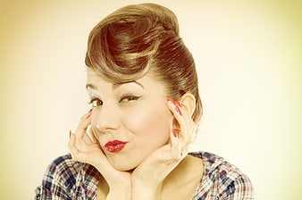 Retro pin-up woman with vintage hairstyle and red lipstick
