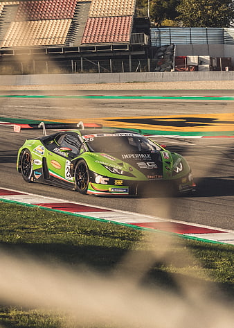 Green Lamborghini GT3 race car speeding on track