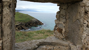 Coastal landscape view through ancient stone ruins