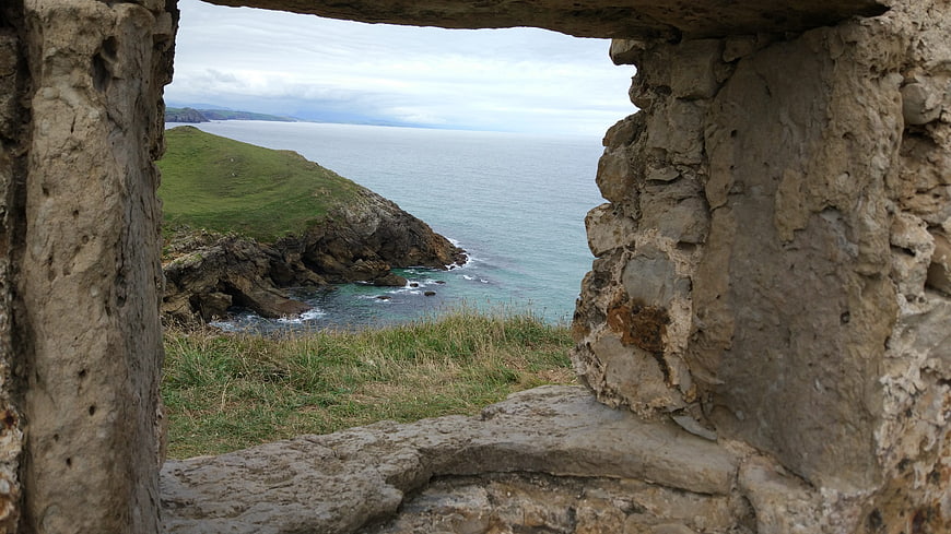 Coastal landscape view through ancient stone ruins