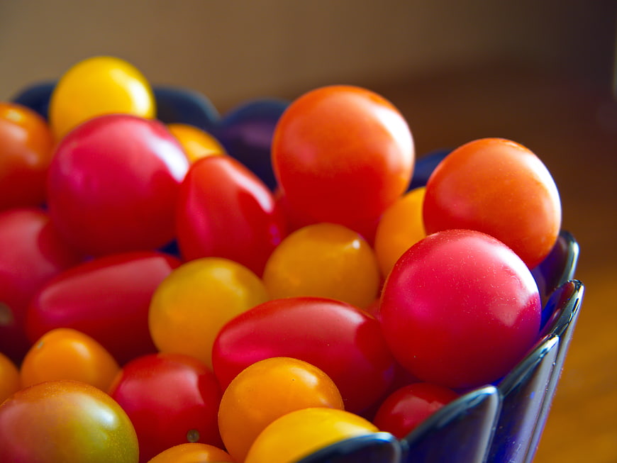 Close-up of colorful cherry tomatoes in a blue bowl