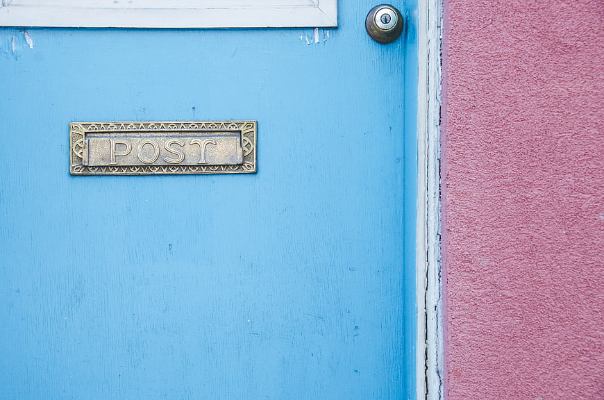 Blue Door with Brass Mail Slot and Pink Wall