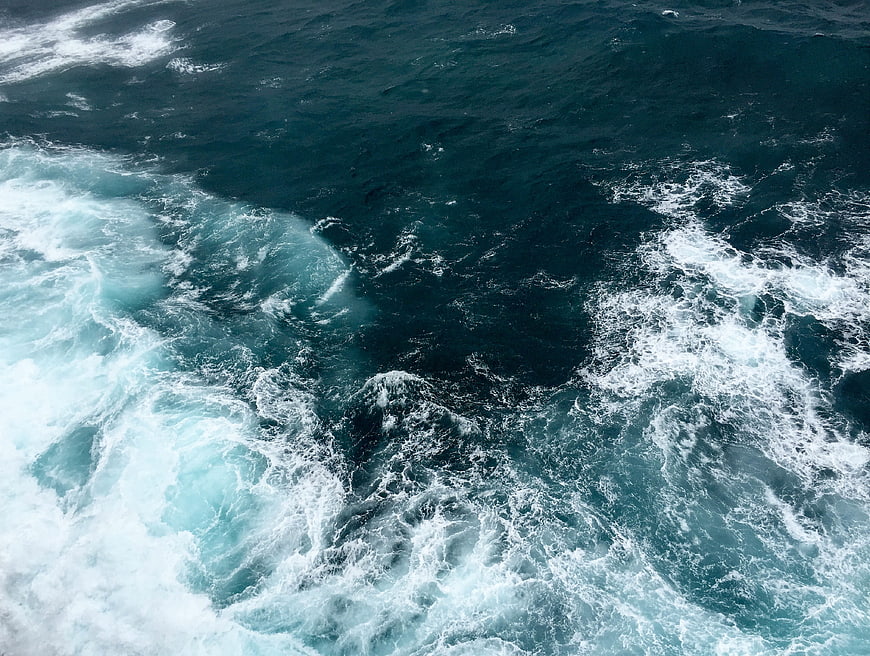 Aerial View of Turbulent Ocean Waves and White Sea Foam
