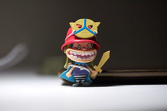 Close-up of a One Piece anime figurine with red hat and sword
